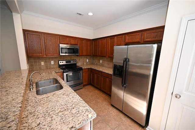 2472 Waterstone Cir, Auburn, AL 36832 - kitchen with appliances with stainless steel finishes, tasteful backsplash, light stone counters, light tile patterned floors, and a peninsula