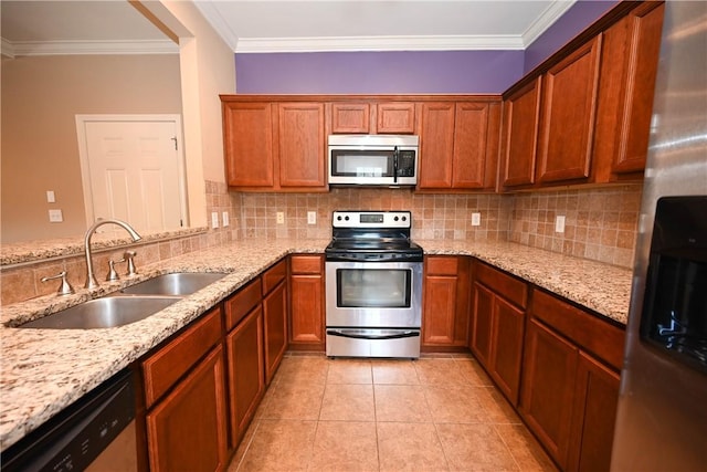 kitchen with tasteful backsplash, sink, light stone counters, and stainless steel appliances