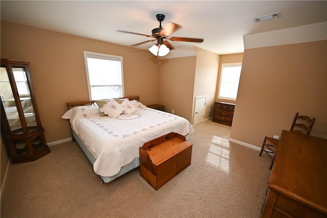 bedroom featuring light colored carpet and ceiling fan