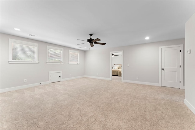 spare room with ceiling fan, light carpet, baseboards, and recessed lighting