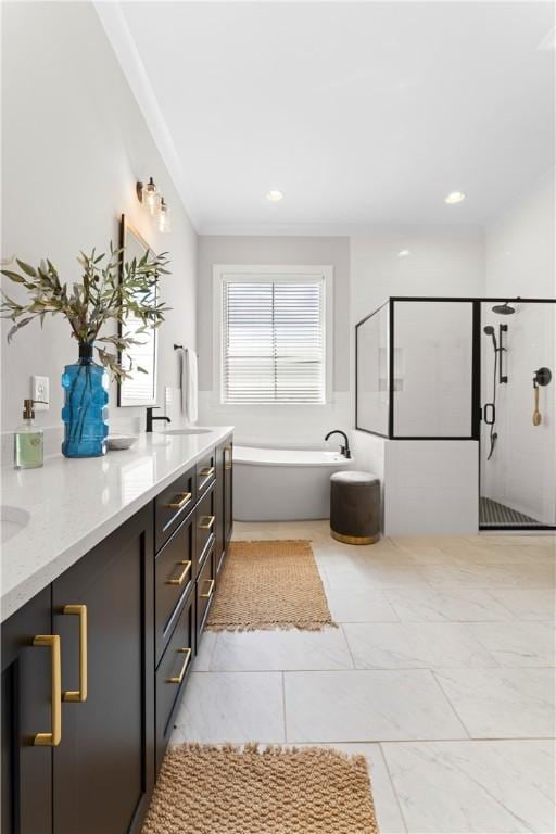 bathroom featuring a freestanding tub, double vanity, a stall shower, and recessed lighting