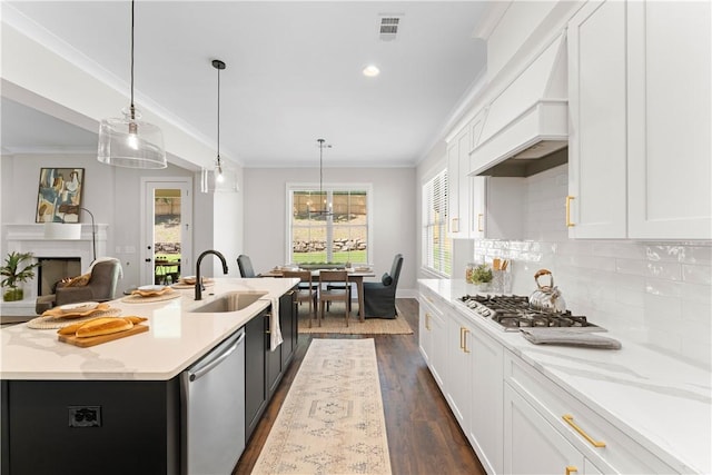 kitchen featuring stainless steel appliances, ornamental molding, dark wood-style flooring, premium range hood, and white cabinetry