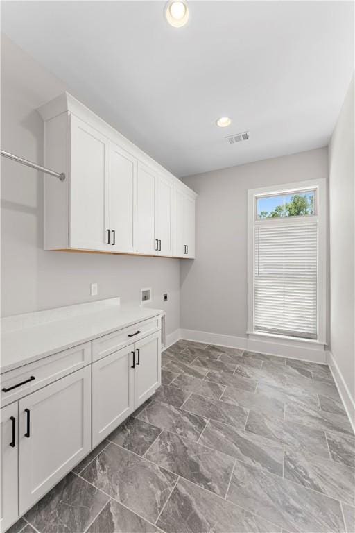 laundry room with cabinet space, electric dryer hookup, baseboards, hookup for a washing machine, and recessed lighting