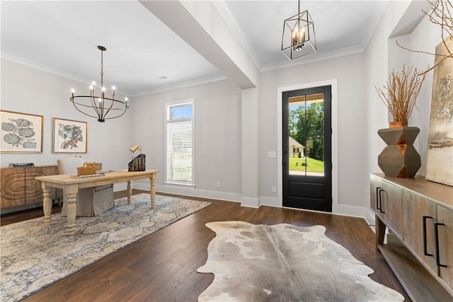 entryway featuring a chandelier, ornamental molding, dark wood-style flooring, and baseboards