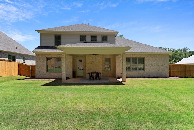 rear view of property featuring brick siding, a patio, and a shingled roof