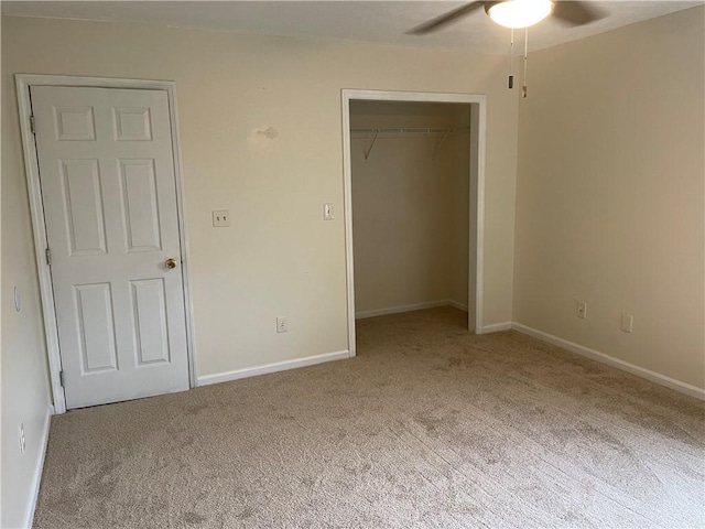 unfurnished bedroom featuring ceiling fan, a closet, and carpet flooring