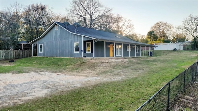 rear view of property with a lawn