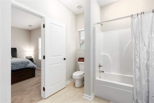 bathroom featuring tile patterned flooring, shower / bathtub combination with curtain, and toilet