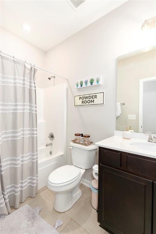 full bathroom with tile patterned flooring, shower / bath combination with curtain, toilet, and vanity