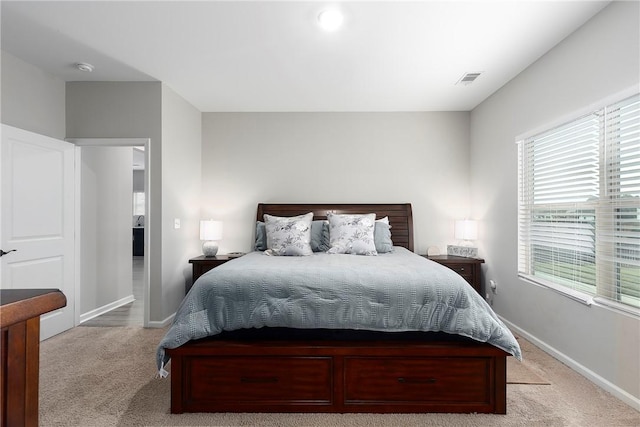 bedroom featuring light carpet