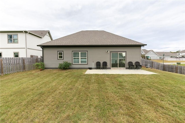 back of property featuring a lawn and a patio