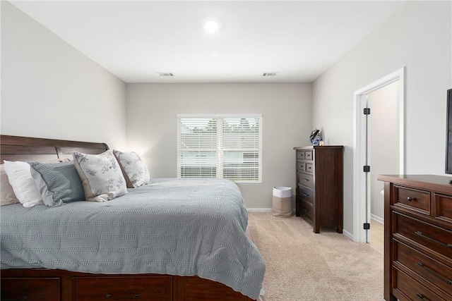 bedroom featuring light carpet