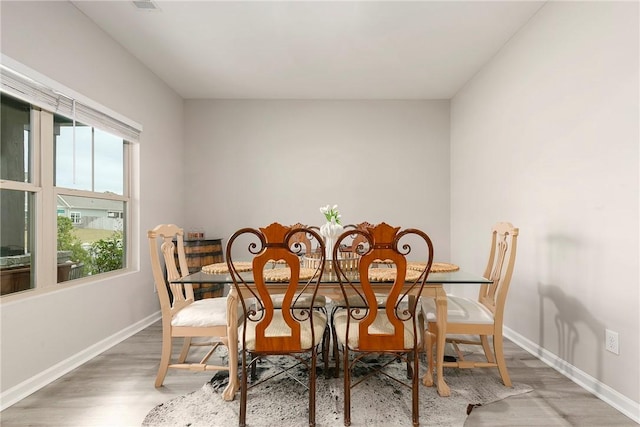 dining space with hardwood / wood-style floors