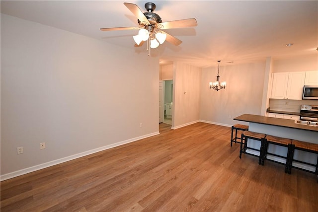 3297 S College St Unit C101, Auburn, AL 36830 - kitchen featuring stainless steel appliances, dark countertops, a chandelier, baseboards, and a ceiling fan