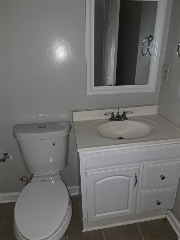 bathroom with toilet, baseboards, and vanity