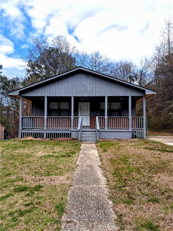 view of front of home featuring covered porch and a front lawn