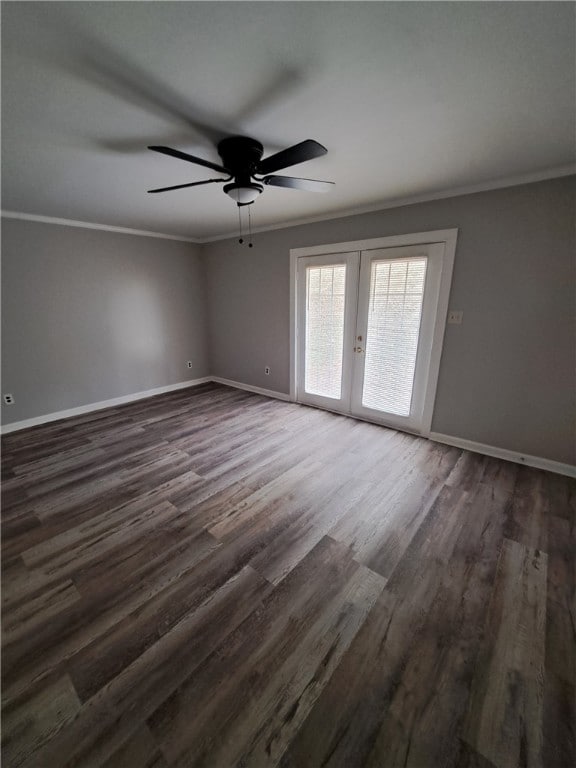 unfurnished room featuring baseboards, dark wood finished floors, ceiling fan, ornamental molding, and french doors