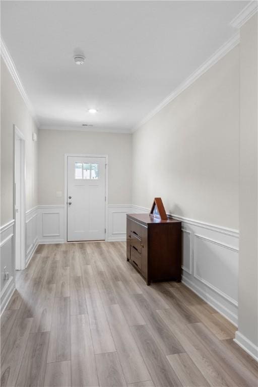 2144 Covey Dr, Auburn, AL 36879 - foyer entrance featuring a decorative wall, ornamental molding, light wood-style floors, and wainscoting