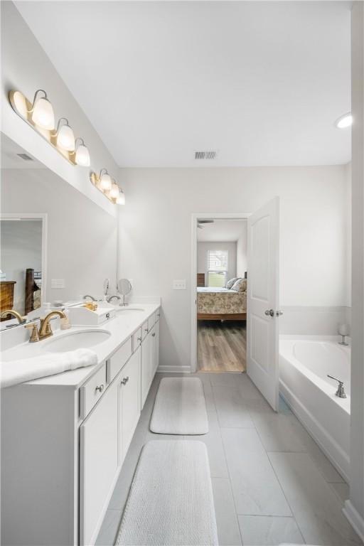 2144 Covey Dr, Auburn, AL 36879 - full bath with ensuite bathroom, double vanity, a bath, and tile patterned flooring