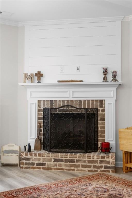 2144 Covey Dr, Auburn, AL 36879 - detailed view of a brick fireplace, wood finished floors, and crown molding