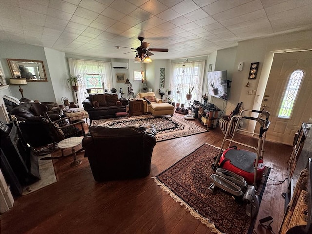 108 Carr St, Tallassee, AL 36078 - living room with a wall mounted air conditioner, plenty of natural light, and hardwood / wood-style flooring