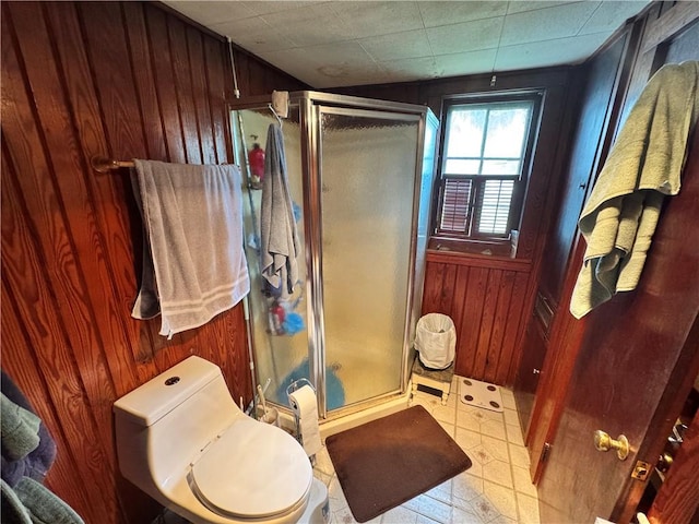 108 Carr St, Tallassee, AL 36078 - bathroom with wooden walls, a stall shower, and toilet