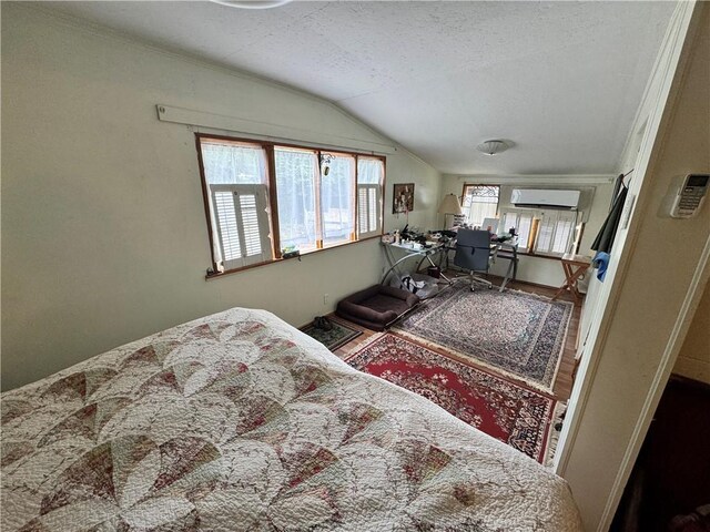 108 Carr St, Tallassee, AL 36078 - bedroom featuring an office area, vaulted ceiling, a wall mounted AC, and a textured ceiling