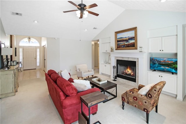 living room featuring lofted ceiling, light carpet, visible vents, and a tiled fireplace