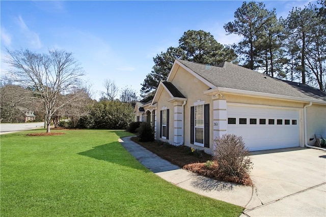 view of side of property with a garage, a yard, driveway, and stucco siding