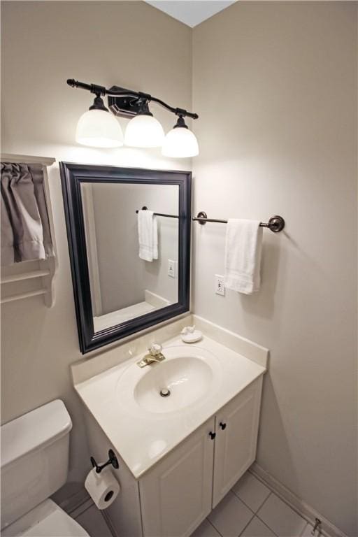 bathroom featuring vanity, toilet, and tile patterned floors