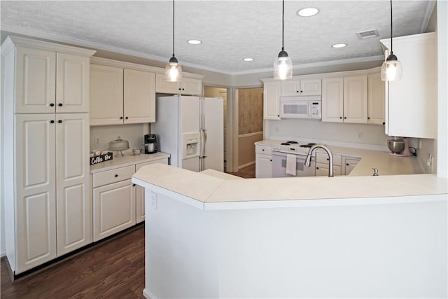 kitchen with light countertops, white appliances, a peninsula, and hanging light fixtures