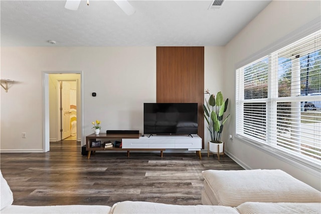 living room with dark hardwood / wood-style floors and ceiling fan