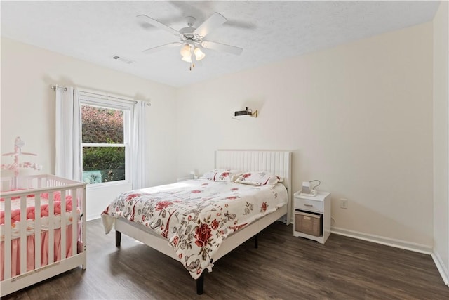 bedroom featuring ceiling fan and dark hardwood / wood-style flooring