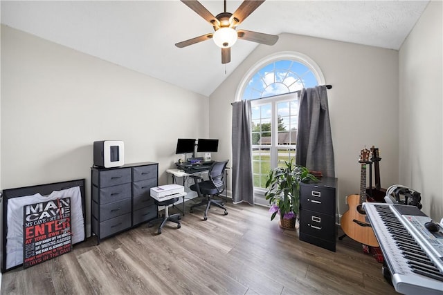 office area featuring a ceiling fan, wood finished floors, and lofted ceiling