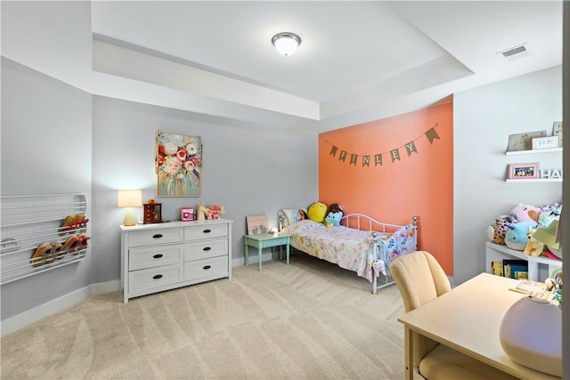 bedroom featuring baseboards, a tray ceiling, light colored carpet, and visible vents