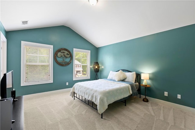 bedroom featuring baseboards, vaulted ceiling, carpet flooring, and visible vents
