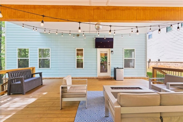 deck with an outdoor living space with a fire pit