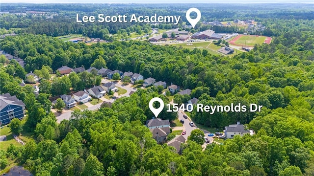 drone / aerial view featuring a residential view and a wooded view