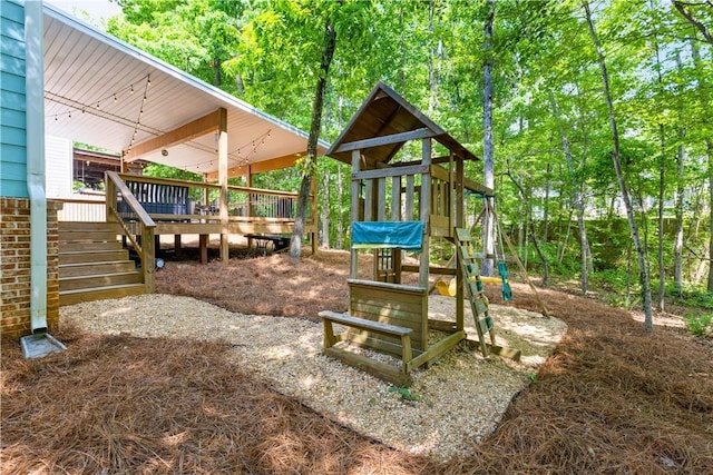view of playground with stairs and a deck