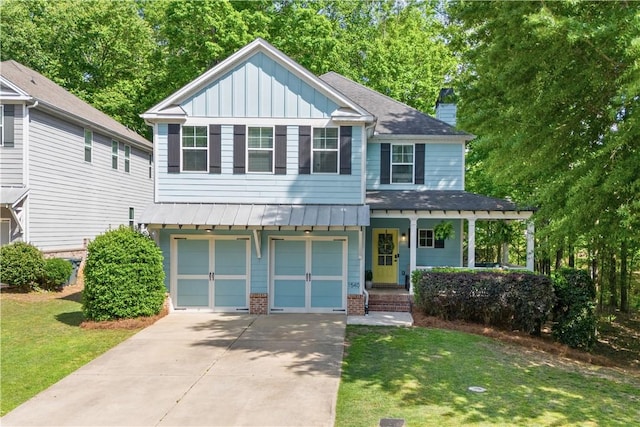 view of front of home featuring a garage, a front yard, board and batten siding, a porch, and driveway