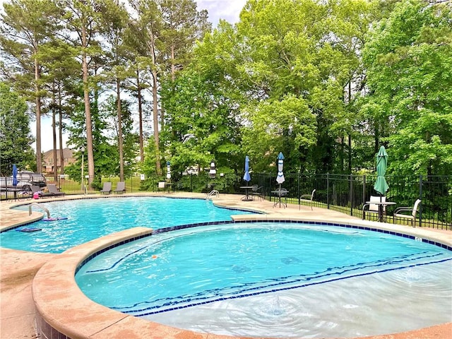 community pool featuring a patio and fence