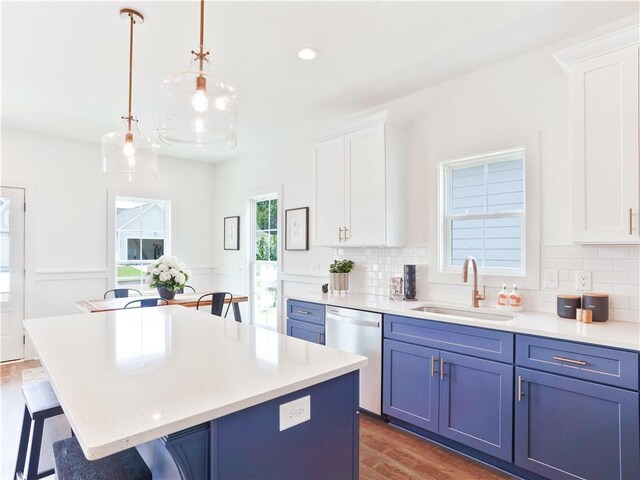 1027 Crossing Ct E, Valley, AL 36854 - kitchen featuring stainless steel dishwasher, blue cabinets, a breakfast bar, a center island, and recessed lighting