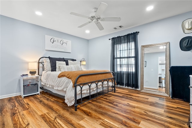 bedroom with recessed lighting, wood finished floors, a ceiling fan, baseboards, and visible vents