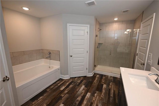 86 Lee Road 2229, Opelika, AL 36804 - bathroom featuring a garden tub, a stall shower, wood finished floors, vanity, and baseboards