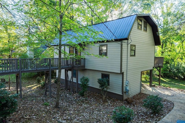 back of property featuring a wooden deck