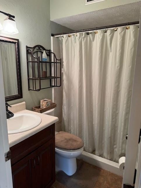 bathroom featuring vanity, toilet, and curtained shower