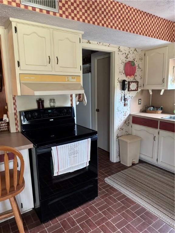 kitchen featuring sink and black electric range oven