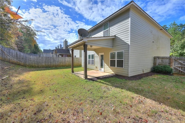 back of property featuring a patio area and a lawn