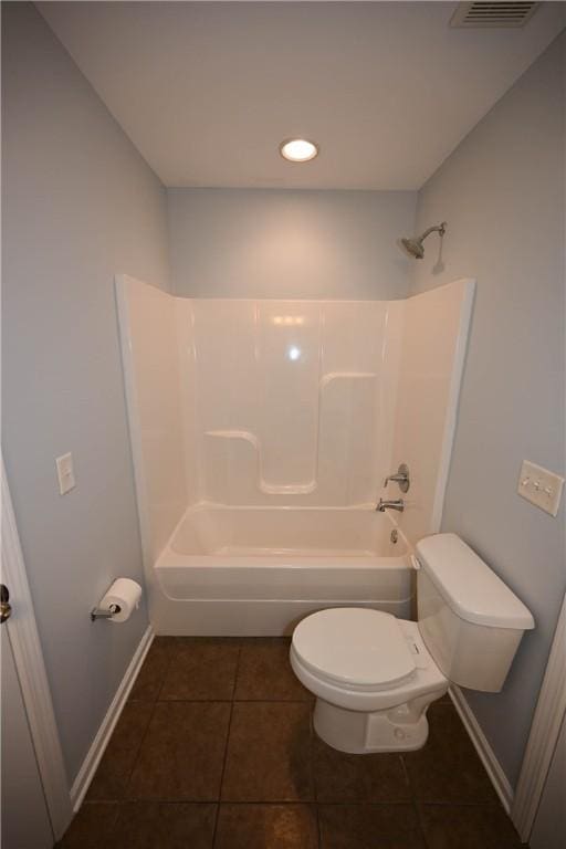 bathroom featuring tile patterned floors, shower / washtub combination, and toilet