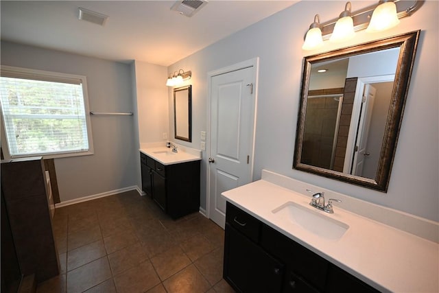 bathroom with tile patterned floors, vanity, and a shower with shower door